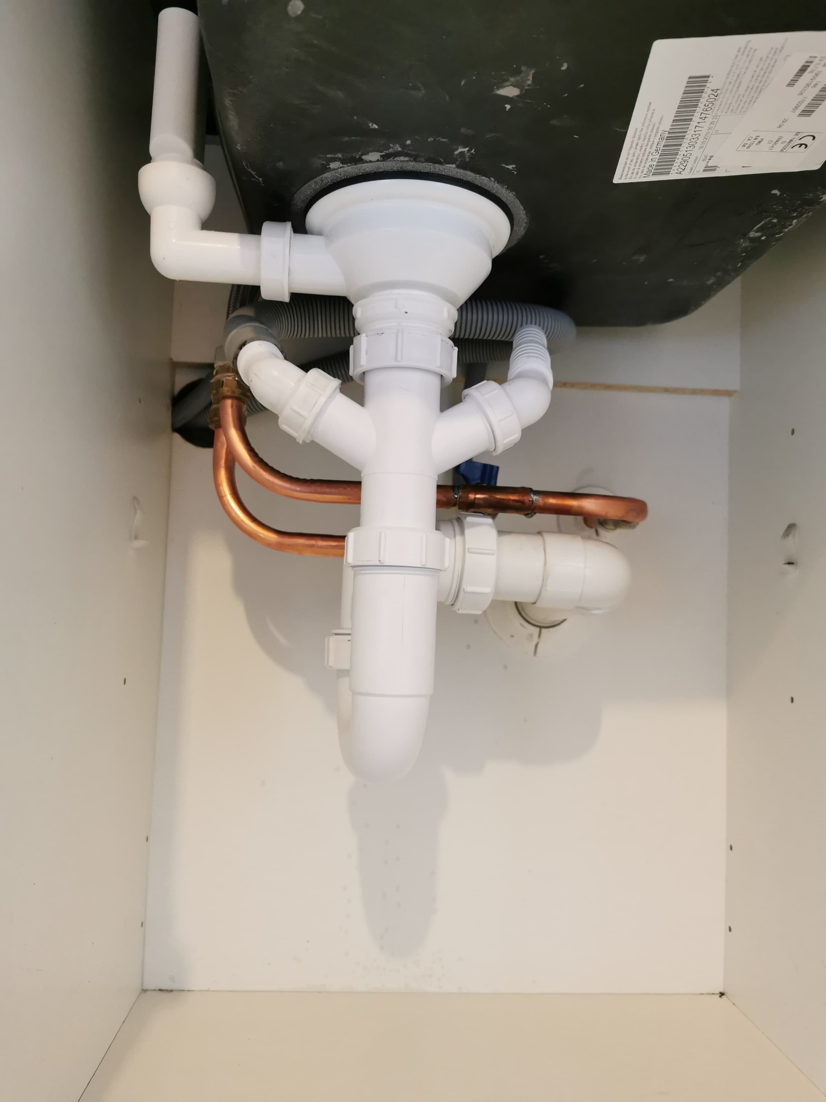 First-fix plumbing under a sink ahead of a bathroom or kitchen fit-out