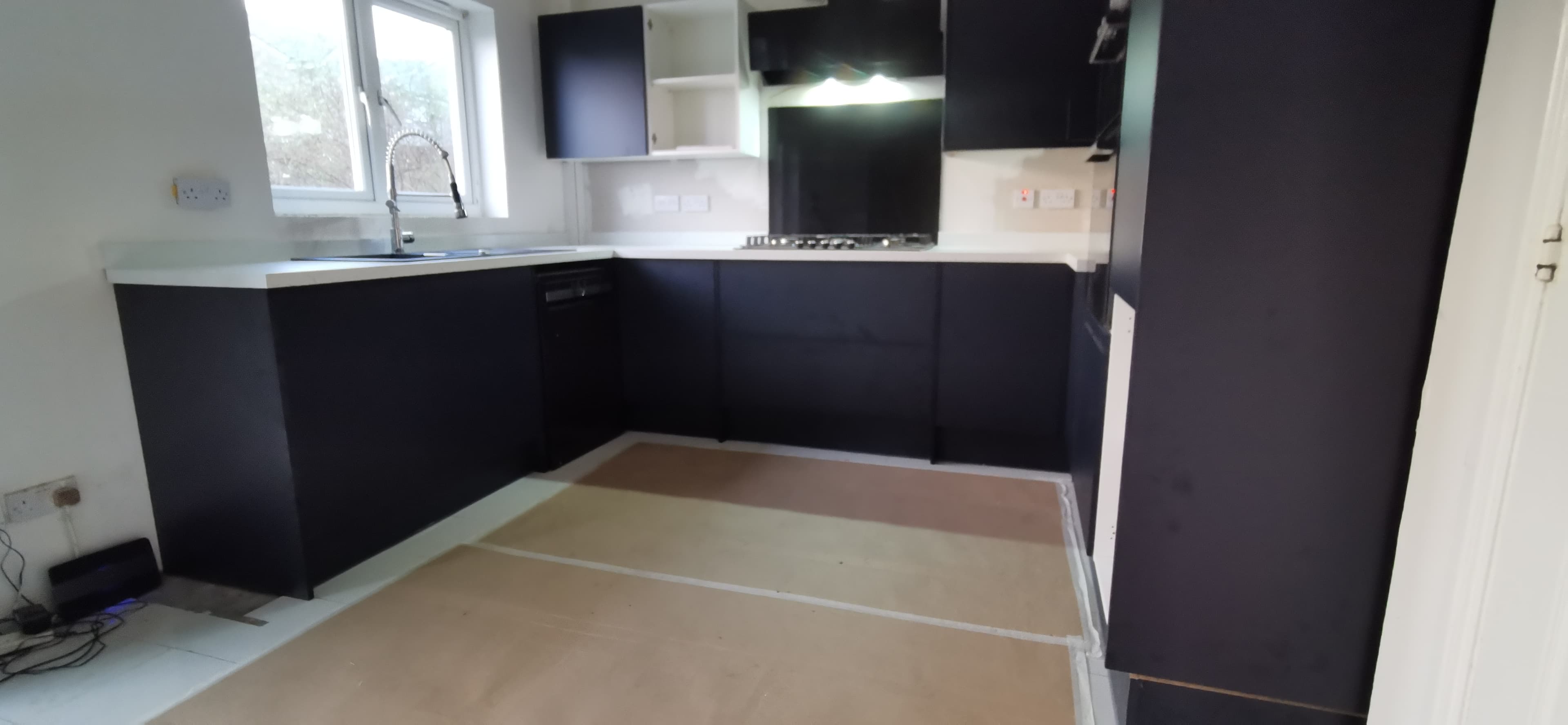 Kitchen fit-out with gas hob, splashback and built-in double oven