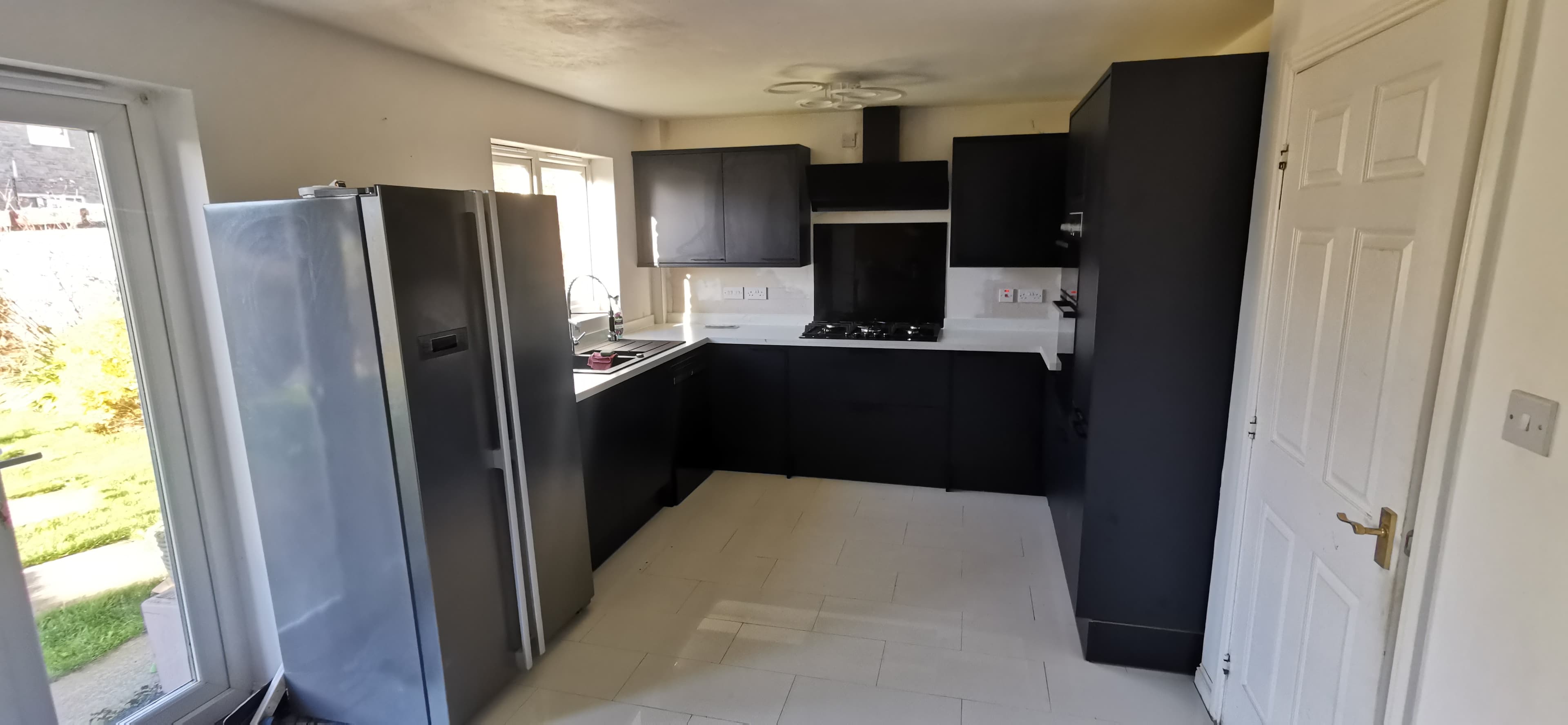 Handleless kitchen cabinetry with quartz worktop and undermount sink