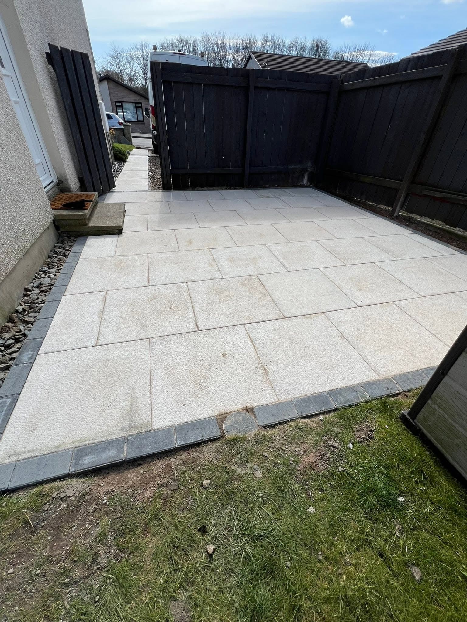 Tiered lawn and porcelain patio landscaping by Greenwell