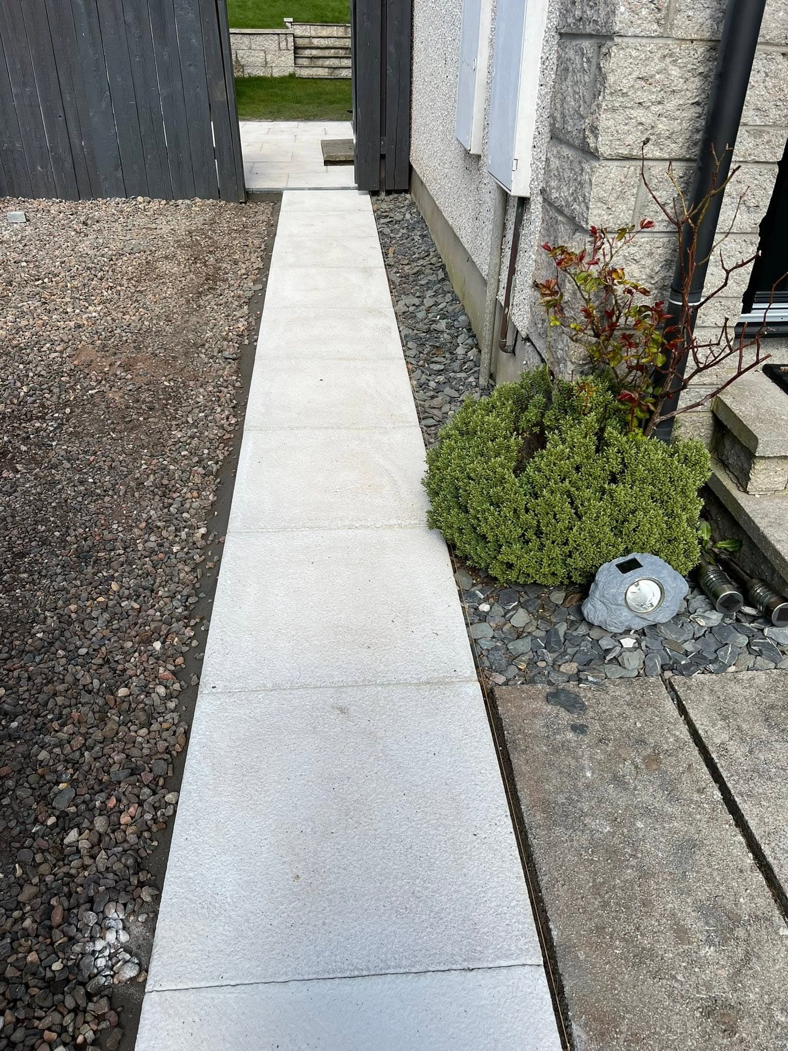 Landscaped garden with slatted timber fencing and clean lawn edges