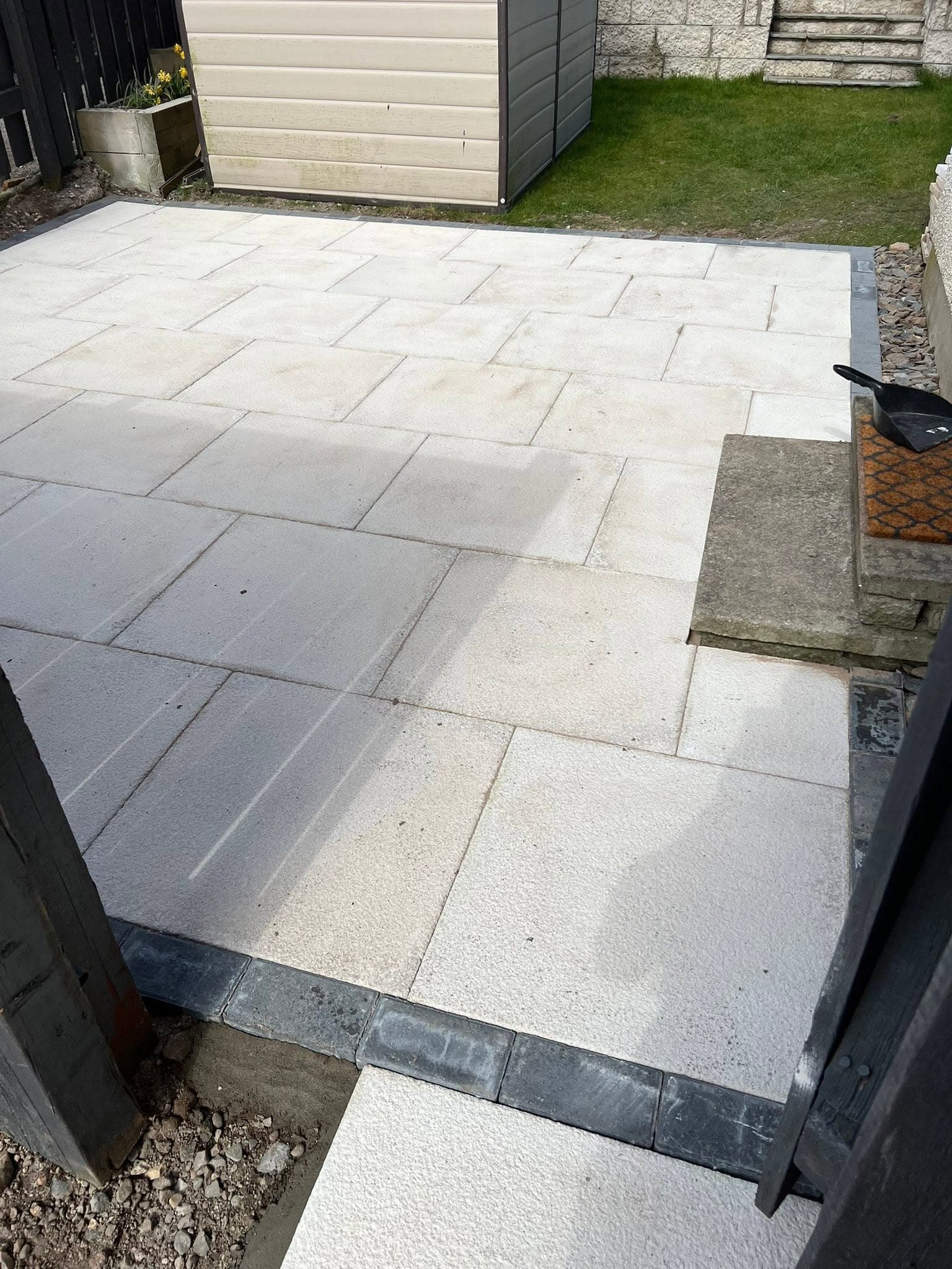Porcelain paved patio and pergola in a completed Greenwell garden