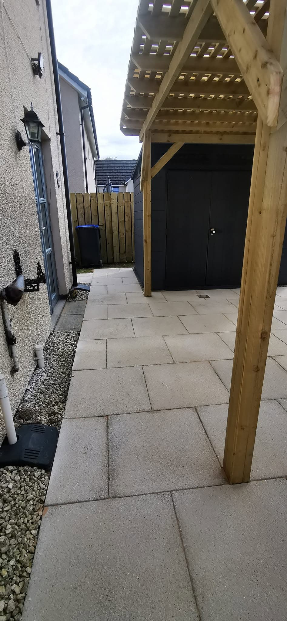 Porcelain paved patio and pergola in a completed Greenwell garden