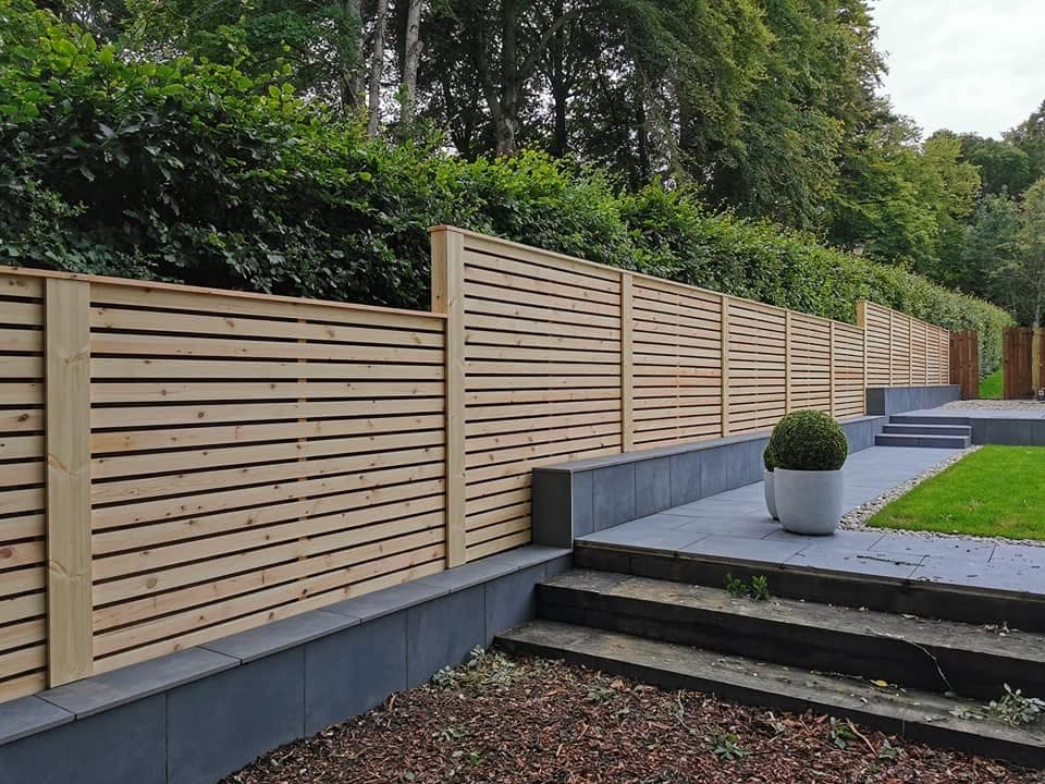 Slatted timber fencing installation